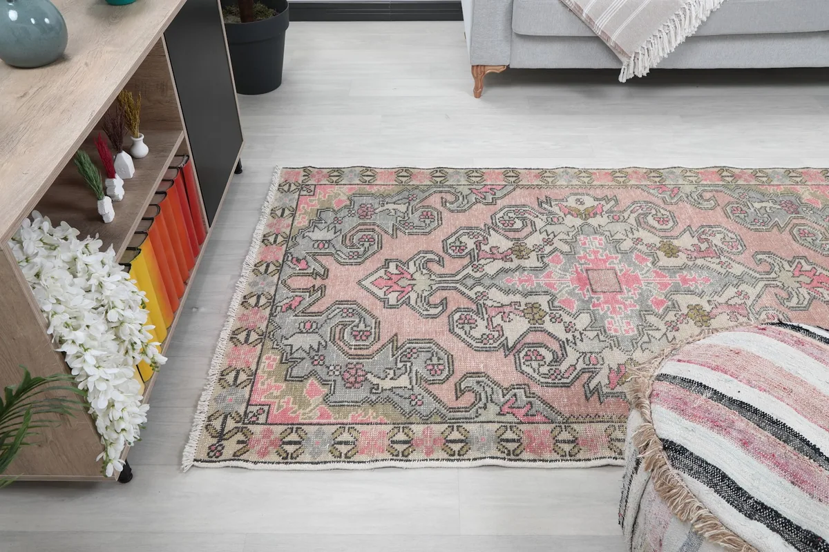 Wide angle view of the rug in a room, capturing its scale and colors.