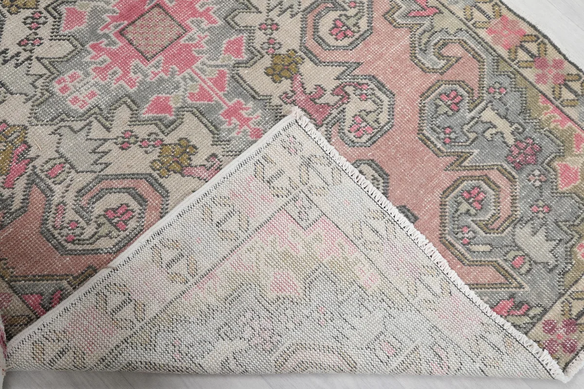 Close-up of the rug's underside, revealing the hand-knotted cotton foundation.
