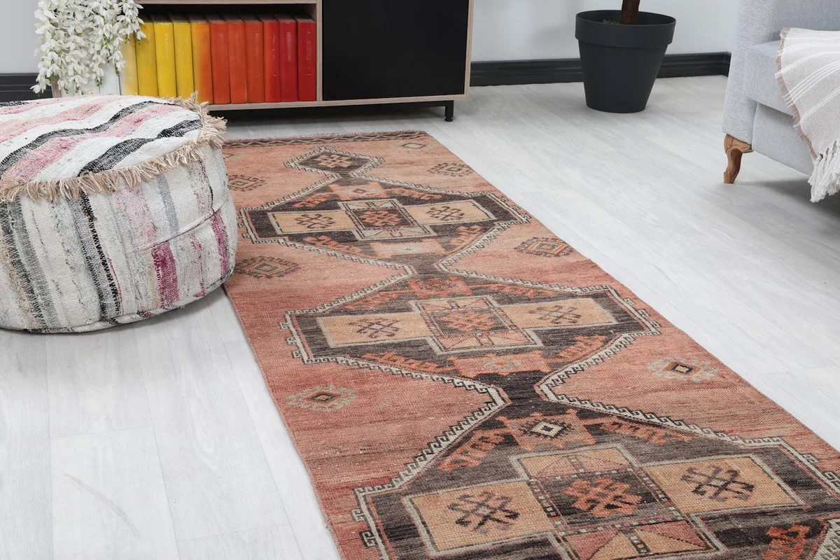 Close-up angle view of the rose runner rug showing tribal motifs