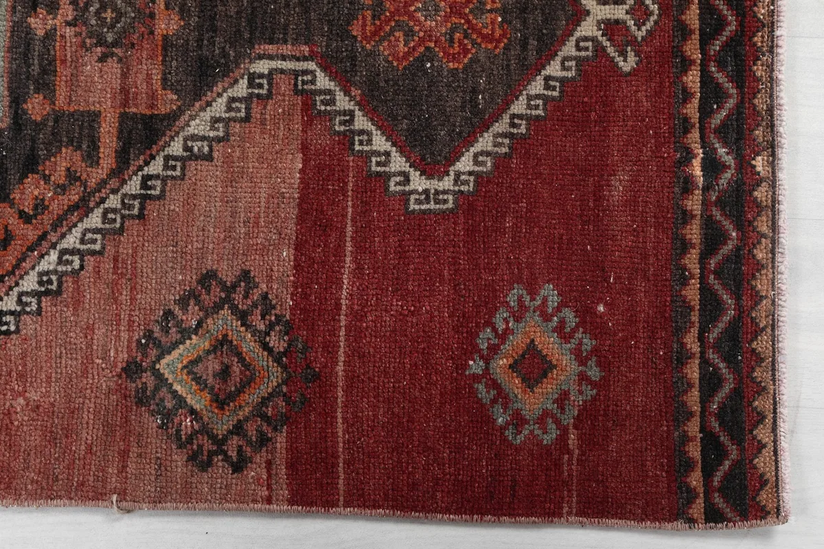 Detail of the runner rug's red section and geometric border patterns