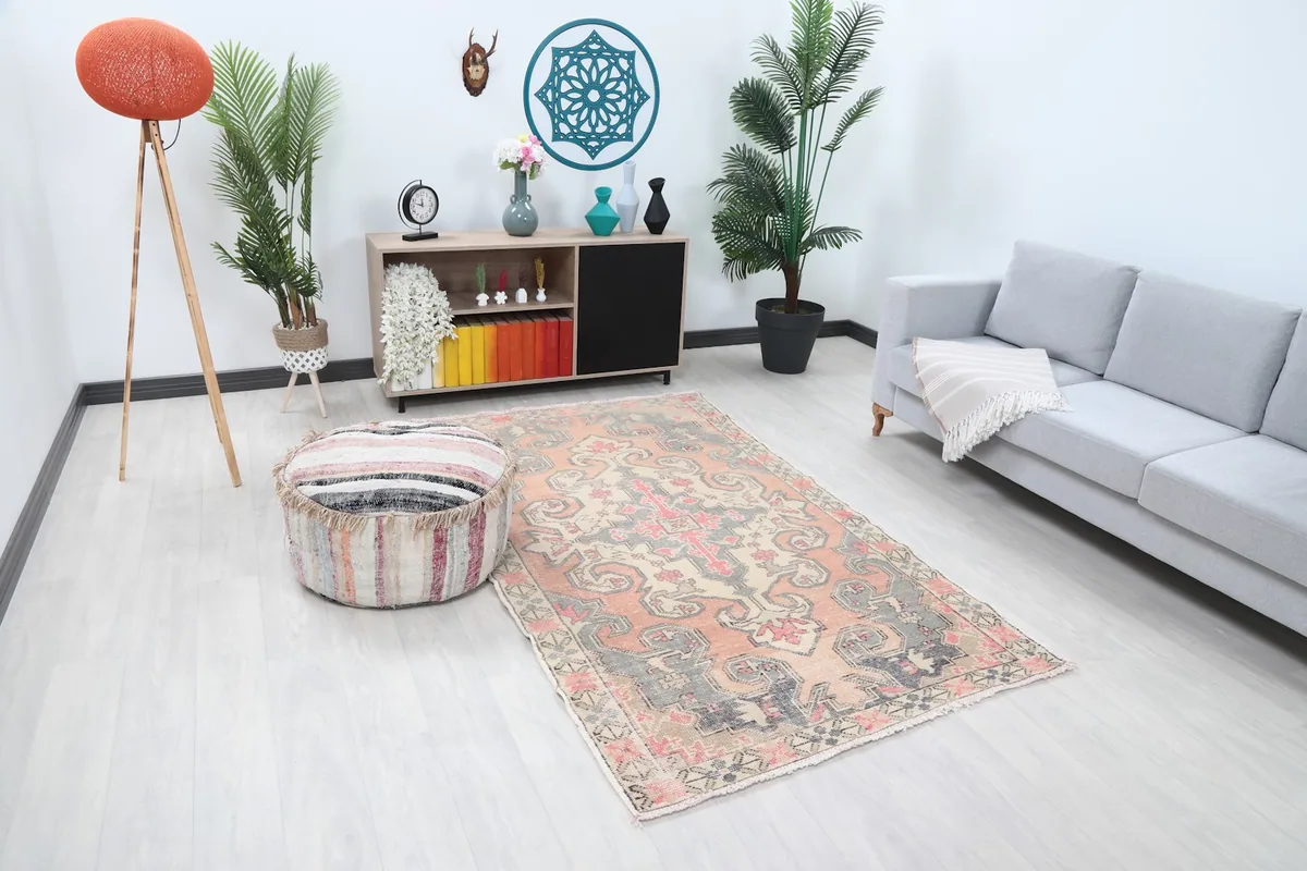 Anatolian area rug with rose and orange tones in a home decor setting