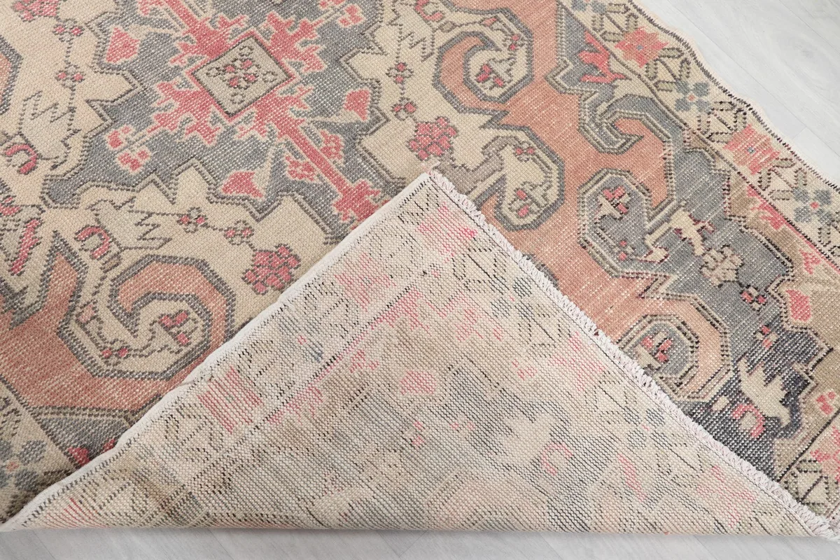 View of the back of the hand-knotted wool rug, showing its cotton foundation and knotting