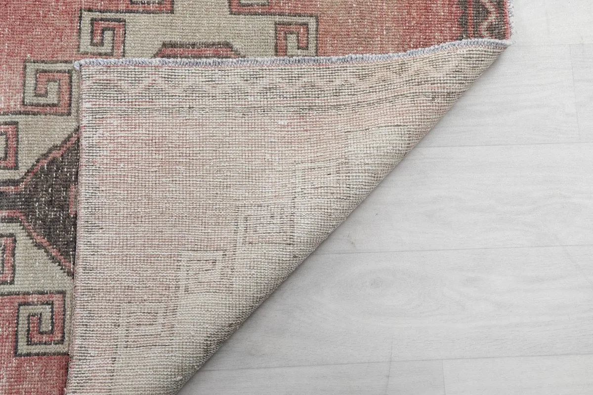 Underside of the rug, showing the reverse of the hand-knotted wool pile and cotton foundation.