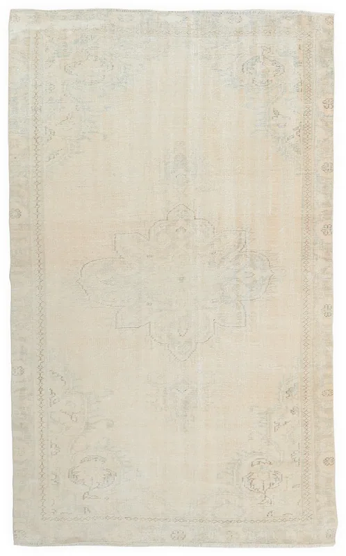 Full overhead view of the 5'4" x 8'8" cream vintage Anatolian rug with a central medallion on a white background.