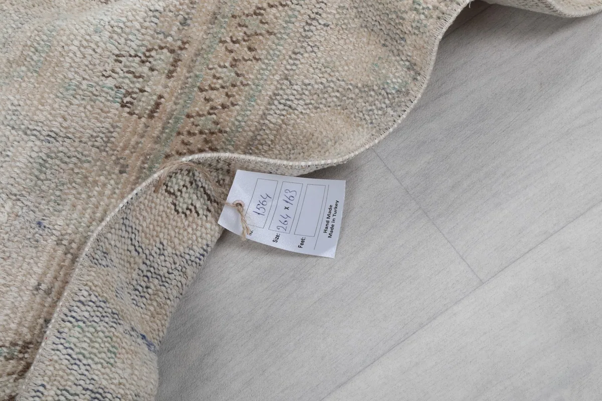 Folded corner of the rug with a tag displaying product information including dimensions.