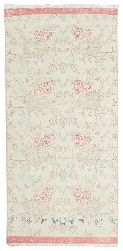 Full top view of the ivory and rose floral vintage Anatolian runner rug on a white background.