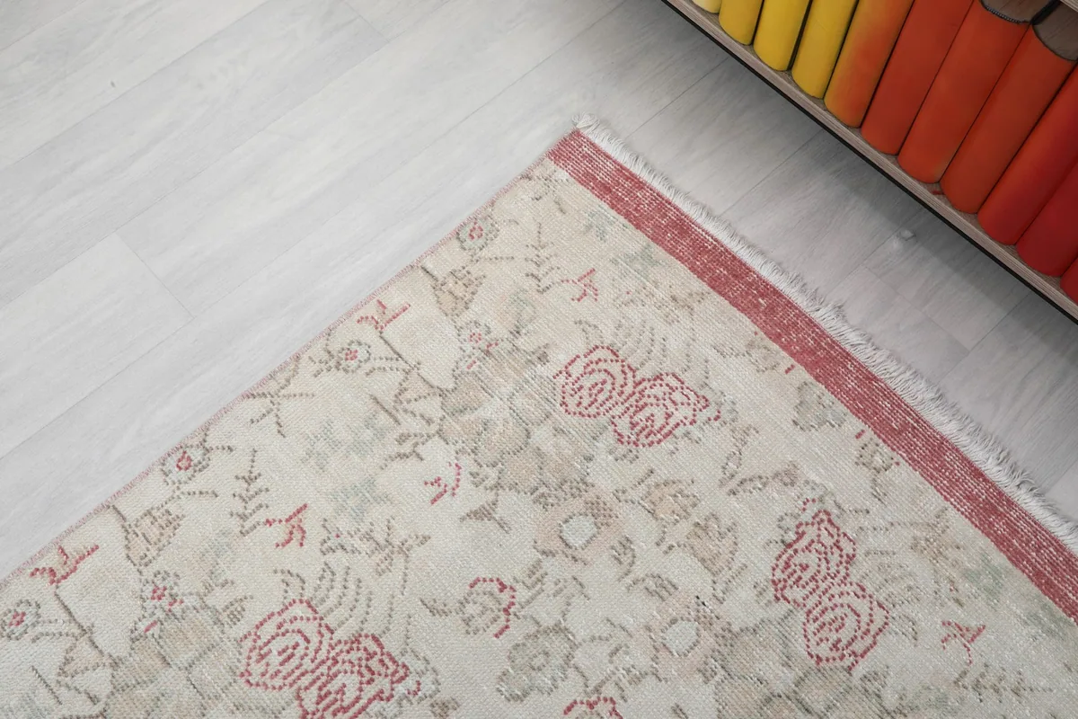 Corner detail of the rug, showing the border and part of the main field pattern.