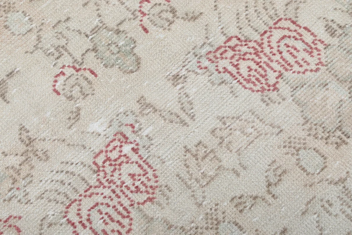 Close-up of the low pile, revealing the intricate knotting and color variations of the wool.