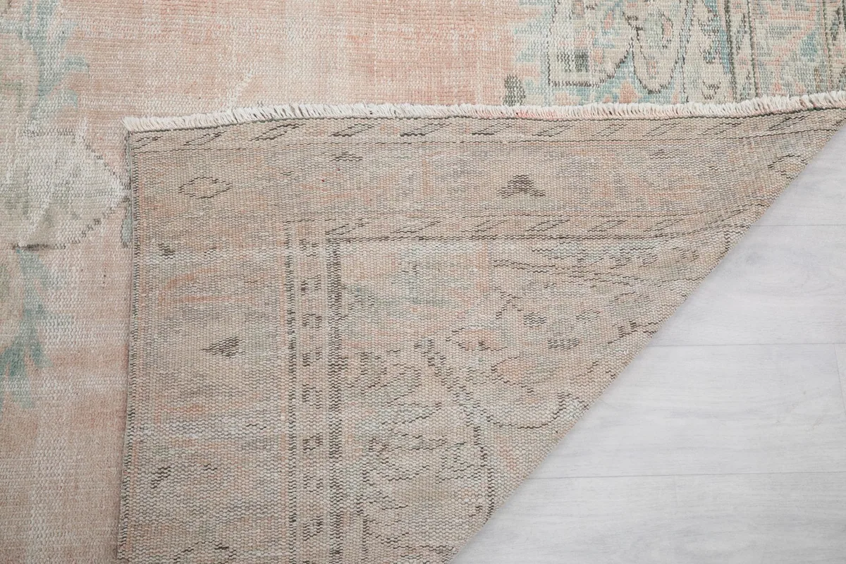 Another view of the rug's reverse side, showing the knotting and fringe detail.