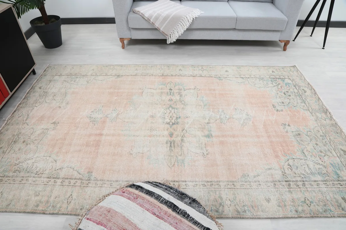 Overhead shot of the rug in a room, emphasizing its size and the subtle distressing.