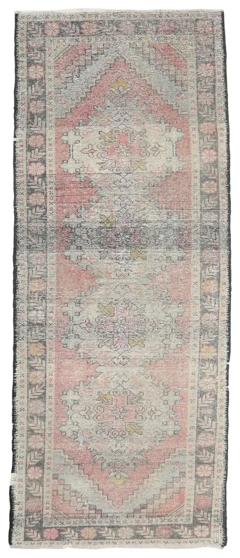 Full overhead view of the 3x9 vintage Anatolian runner rug with rose and charcoal geometric patterns