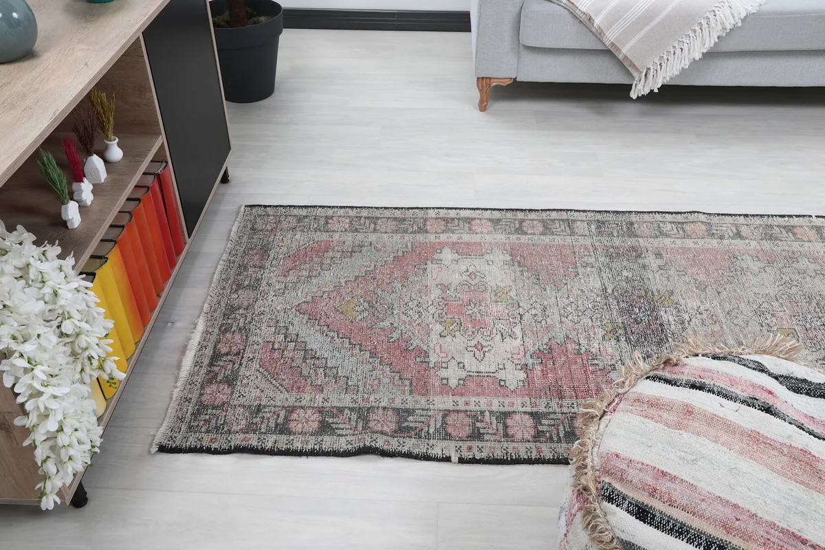 Side view of the vintage runner rug extending along the floor in a living area
