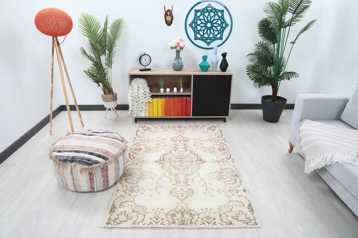 Ivory and rose vintage rug styled in a modern living room setting