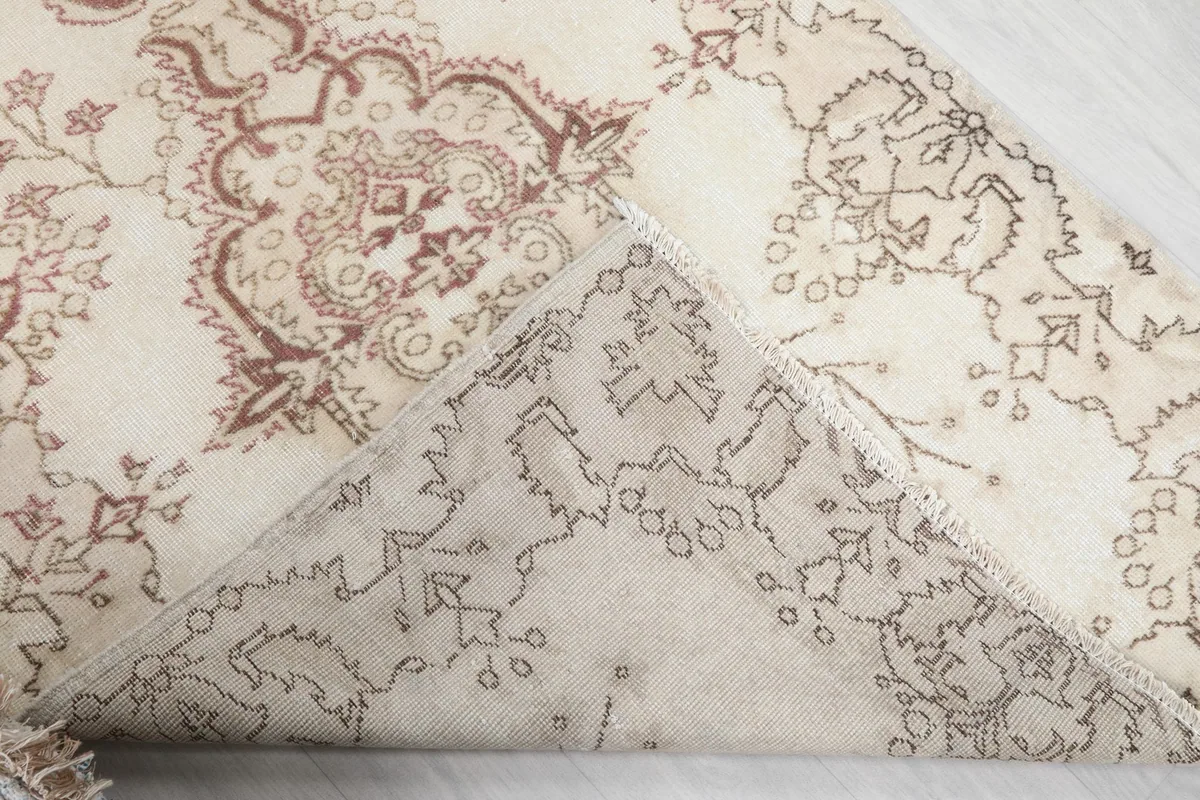 Underside of the rug, revealing the cotton foundation and hand-knotted construction