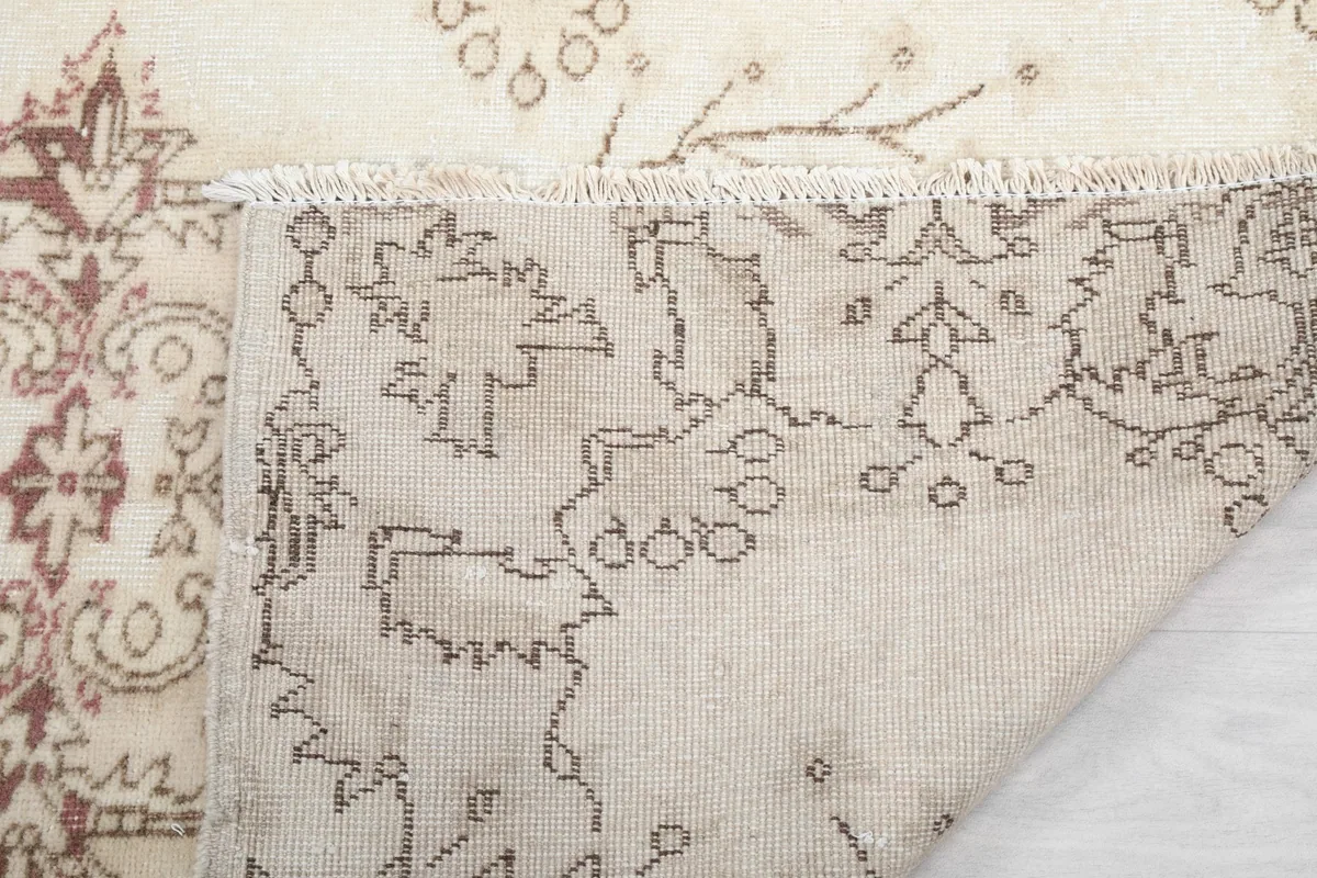 Close-up of the rug's fringe and the back of the hand-knotted wool pile