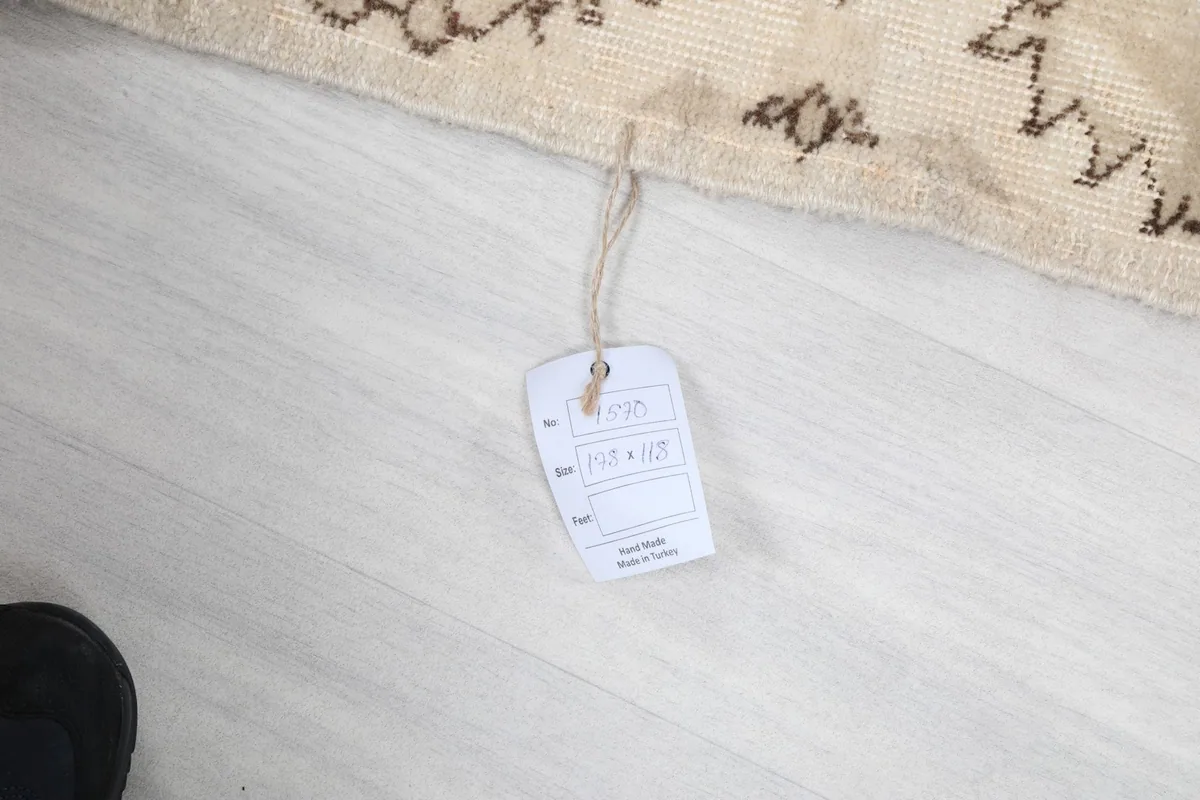 Product tag attached to the rug, displaying size information and origin