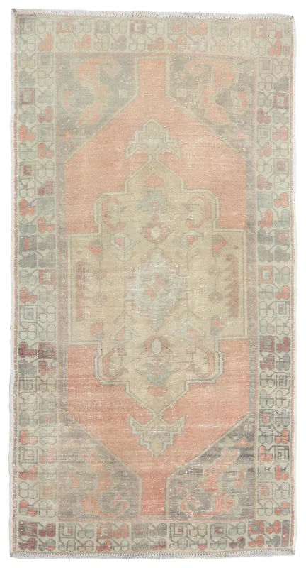 Full top view of the vintage Anatolian rug with a rose field and beige medallion on a white background