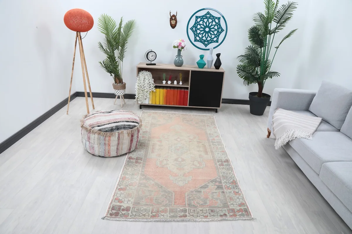 Vintage Anatolian rug in a contemporary living room setting with light flooring and modern furniture