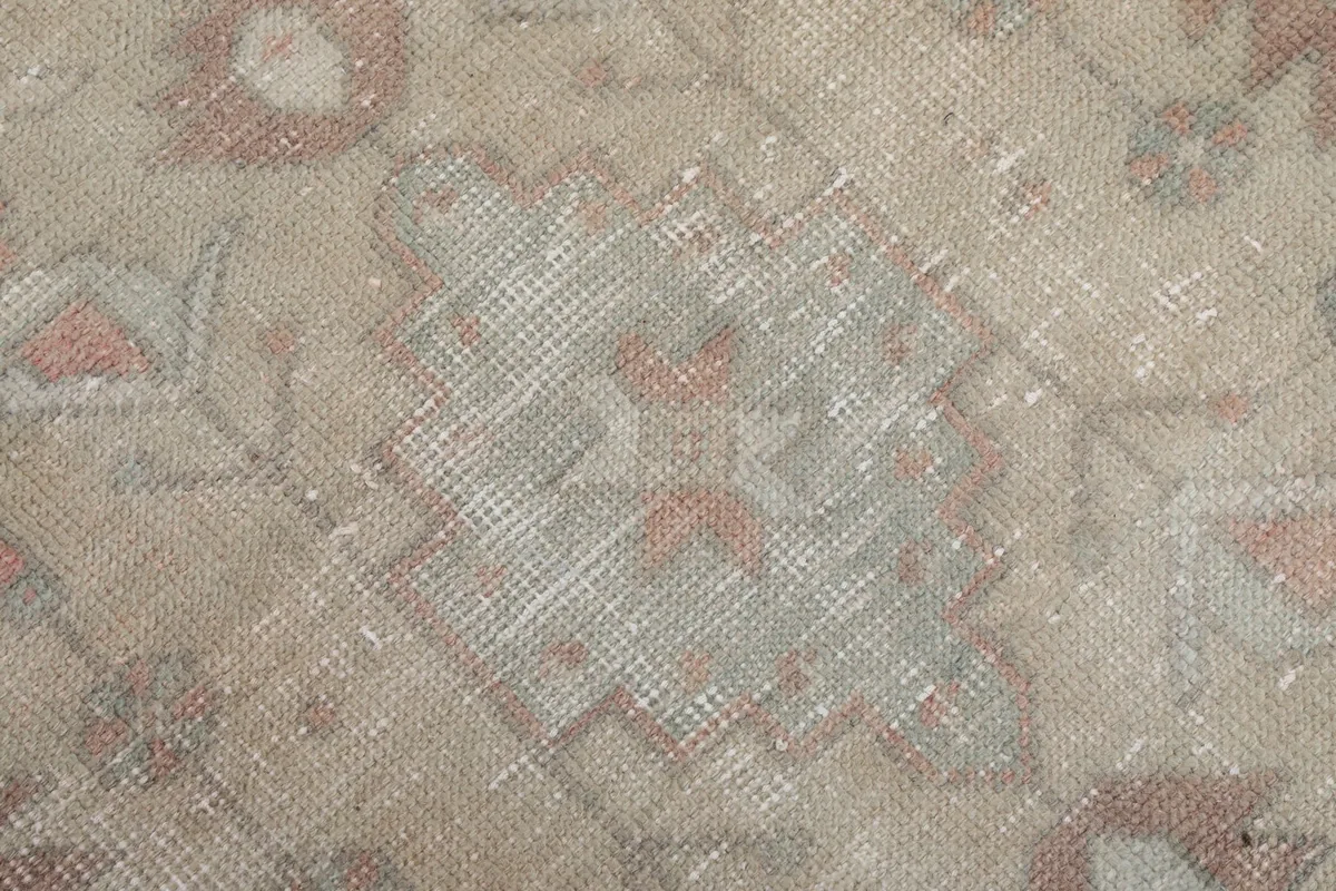 Extreme close-up of the low wool pile, showing the hand-knotted texture and vintage wear