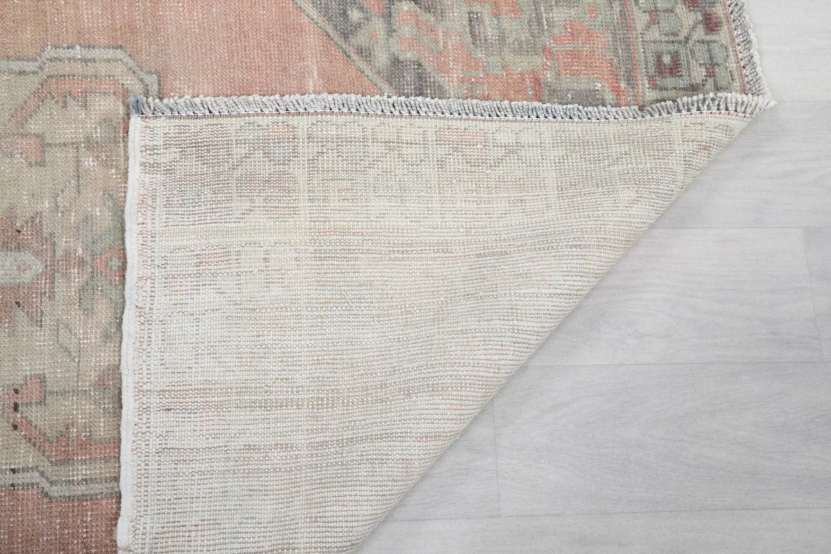 Another angle of the rug's back, revealing the tightly woven cotton foundation and craftsmanship