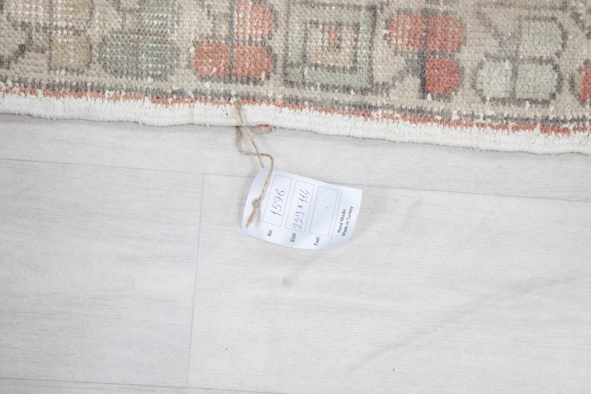 Detail of the rug's edge and fringe, with a product tag attached