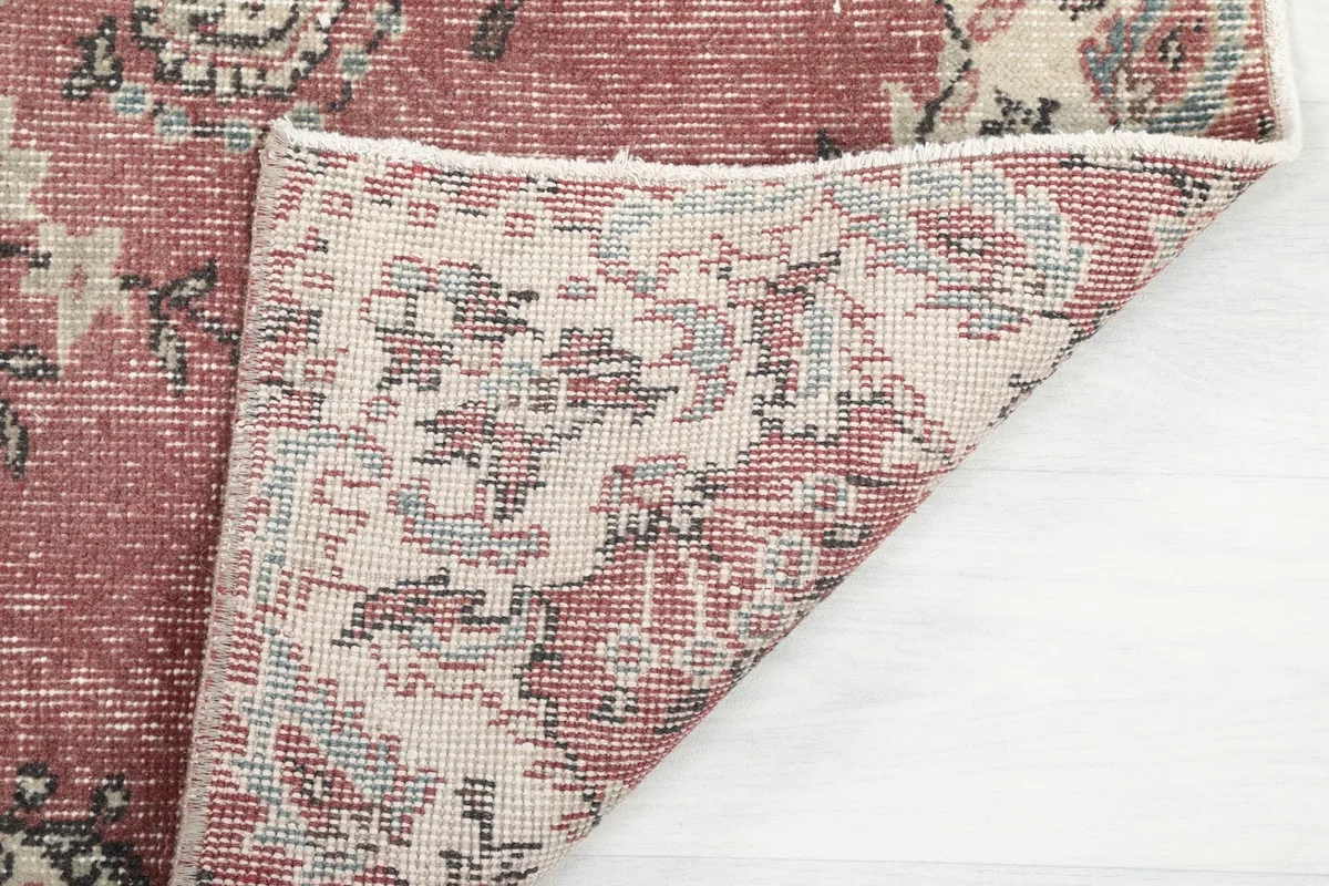 Underside of the rug, showing the hand-knotted construction and cotton foundation.