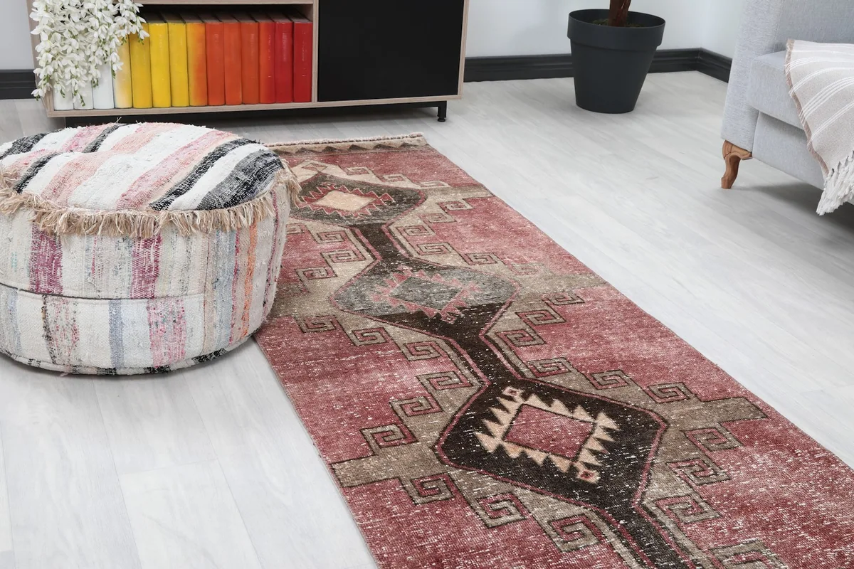 Close-up angle showing the rose field and central black and tan geometric design of the runner.