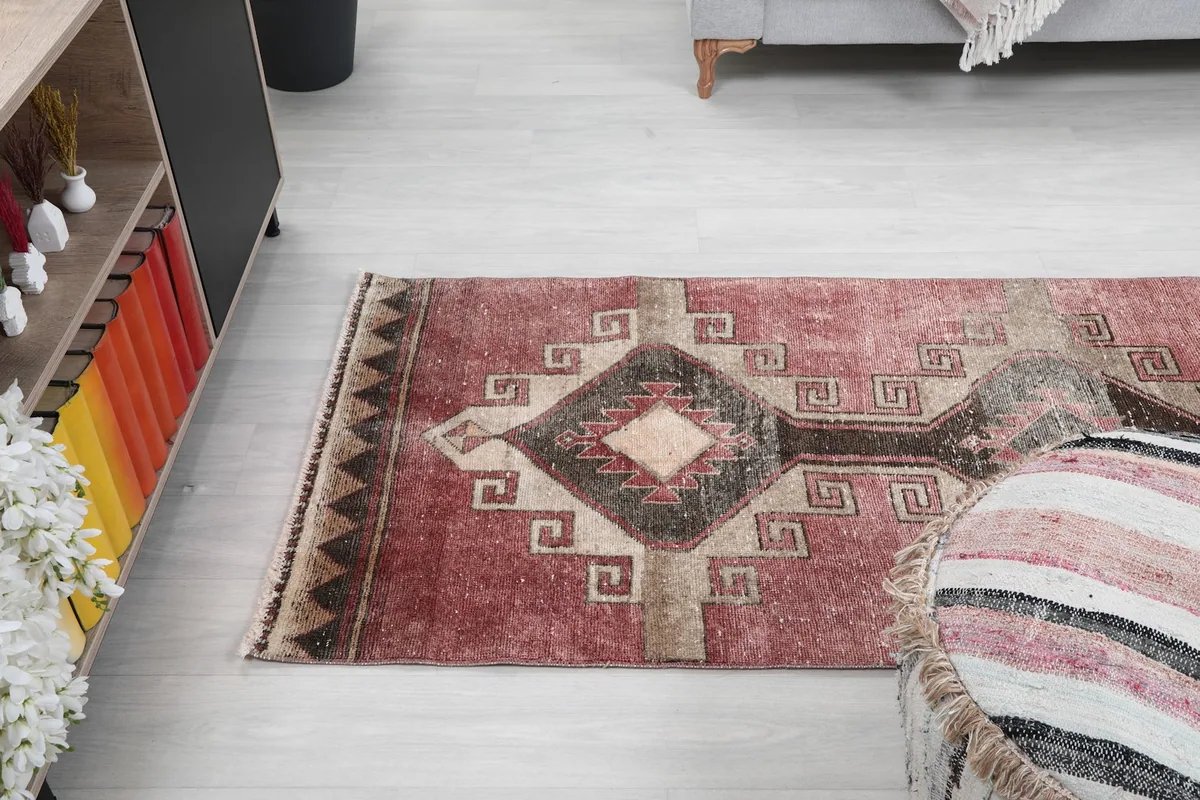 Angled view of the runner rug in a room, emphasizing its long, narrow shape and vibrant colors.