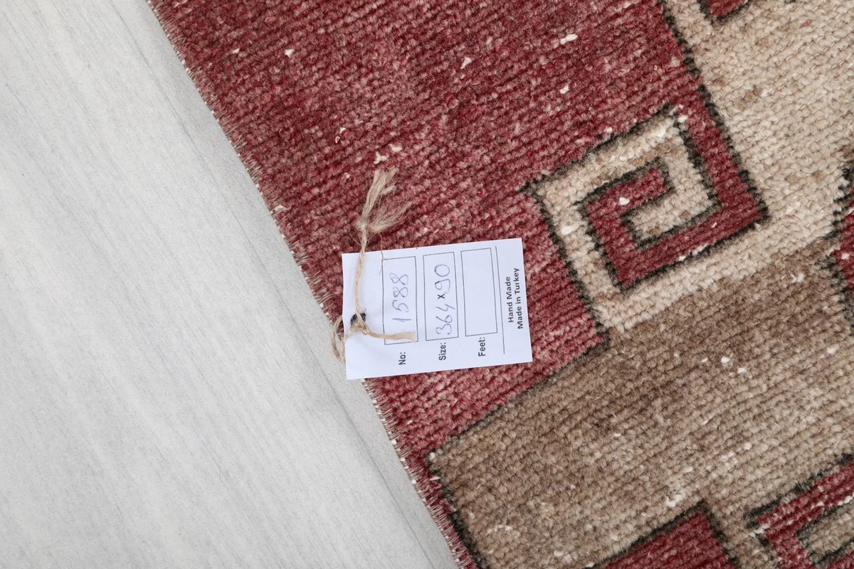 Rug label with product information attached to the corner of the vintage Anatolian runner.