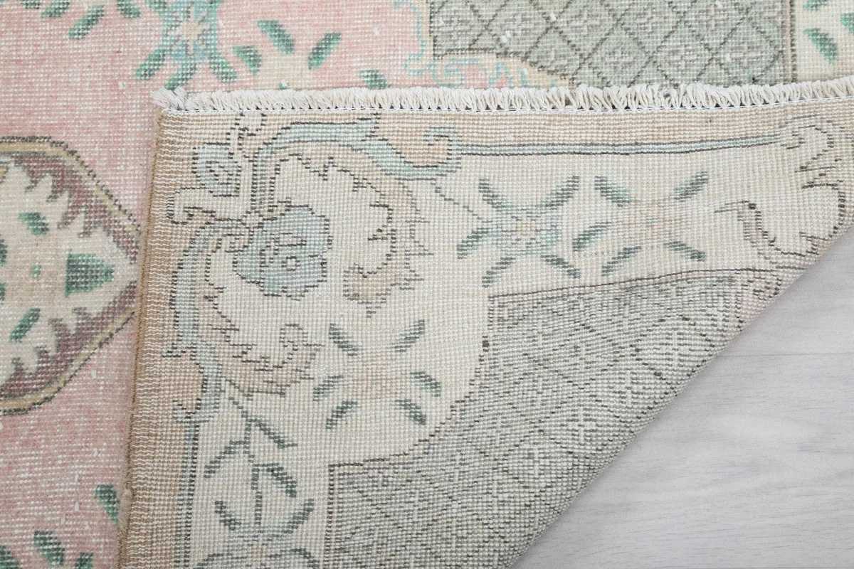 Close-up of the back of the rug, showing the knotting structure and fringe detail