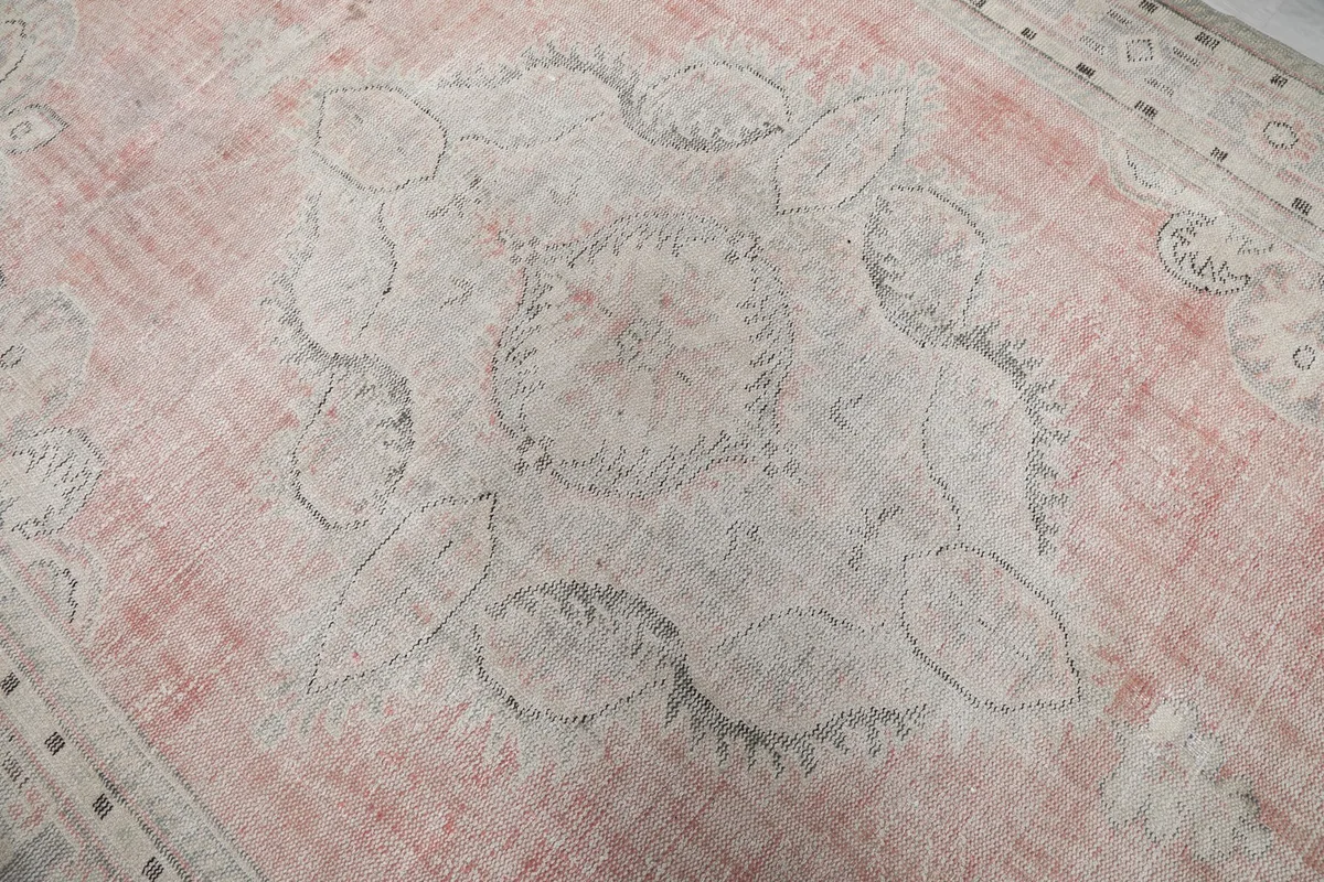 Detailed view of the central medallion on the rose field, highlighting its motifs