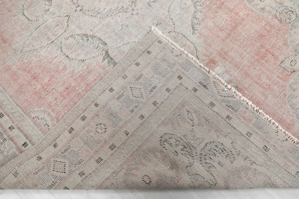 Underside corner of the rug, revealing the cotton foundation and hand-knotted construction