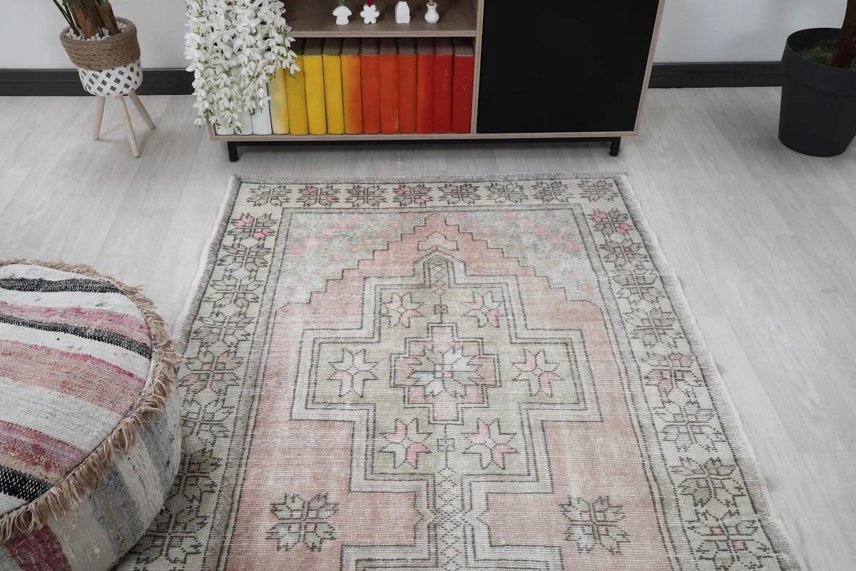 Overhead view of the rug in a room, focusing on its placement relative to a console table and ottoman.