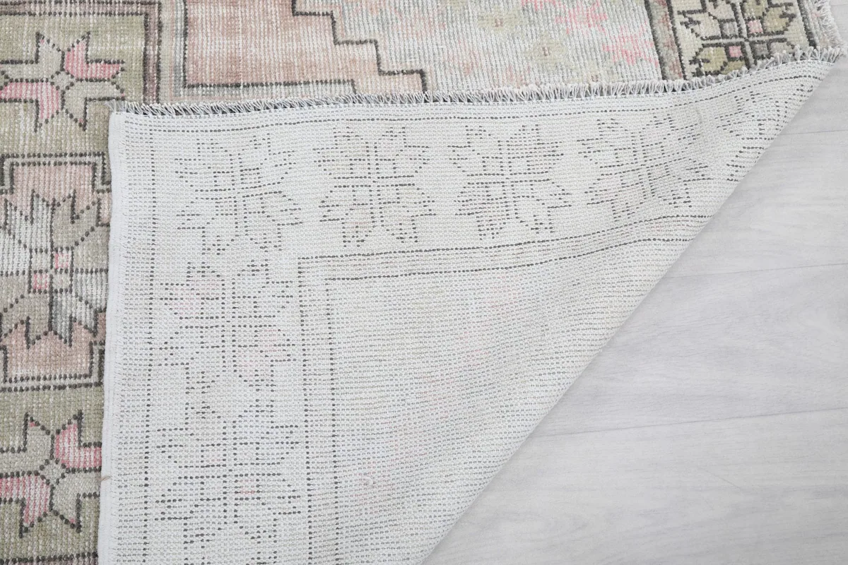 Another view of the rug's back, showing the consistent weave of the cotton foundation.