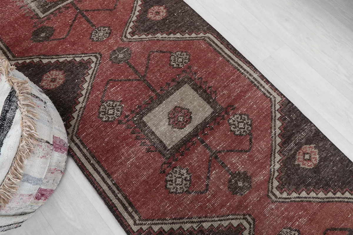 Detail of the rug's central design and colors from an elevated angle
