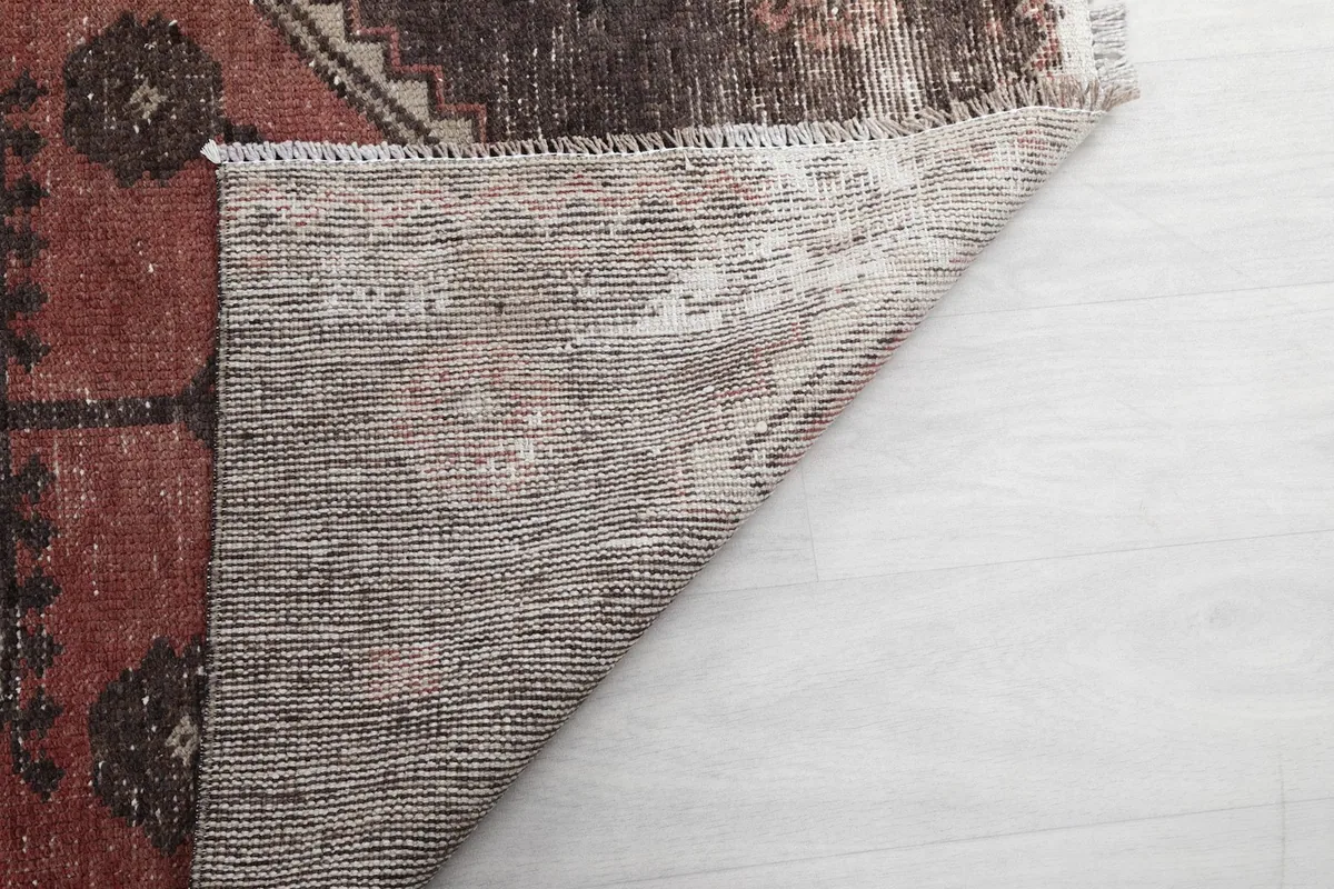 Close-up of the rug's reverse side, showing the tightly woven cotton foundation