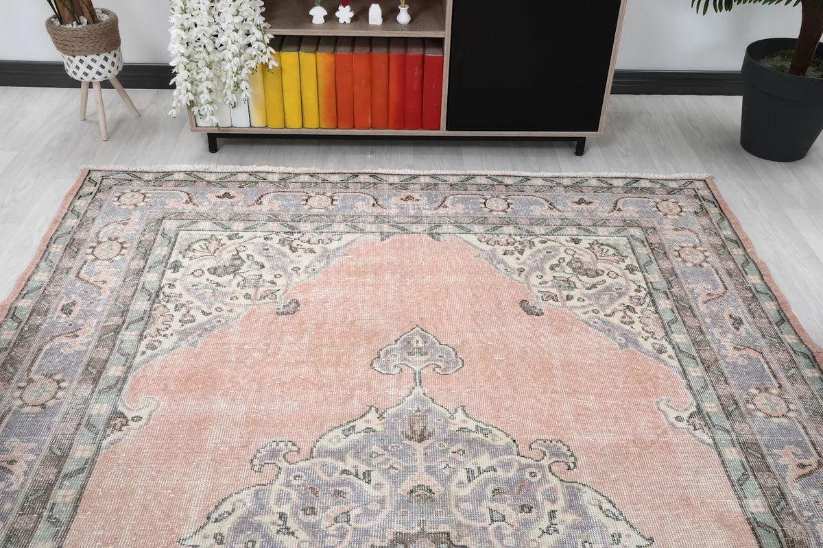 View of the rug from one end in a room setting, showing the full design.