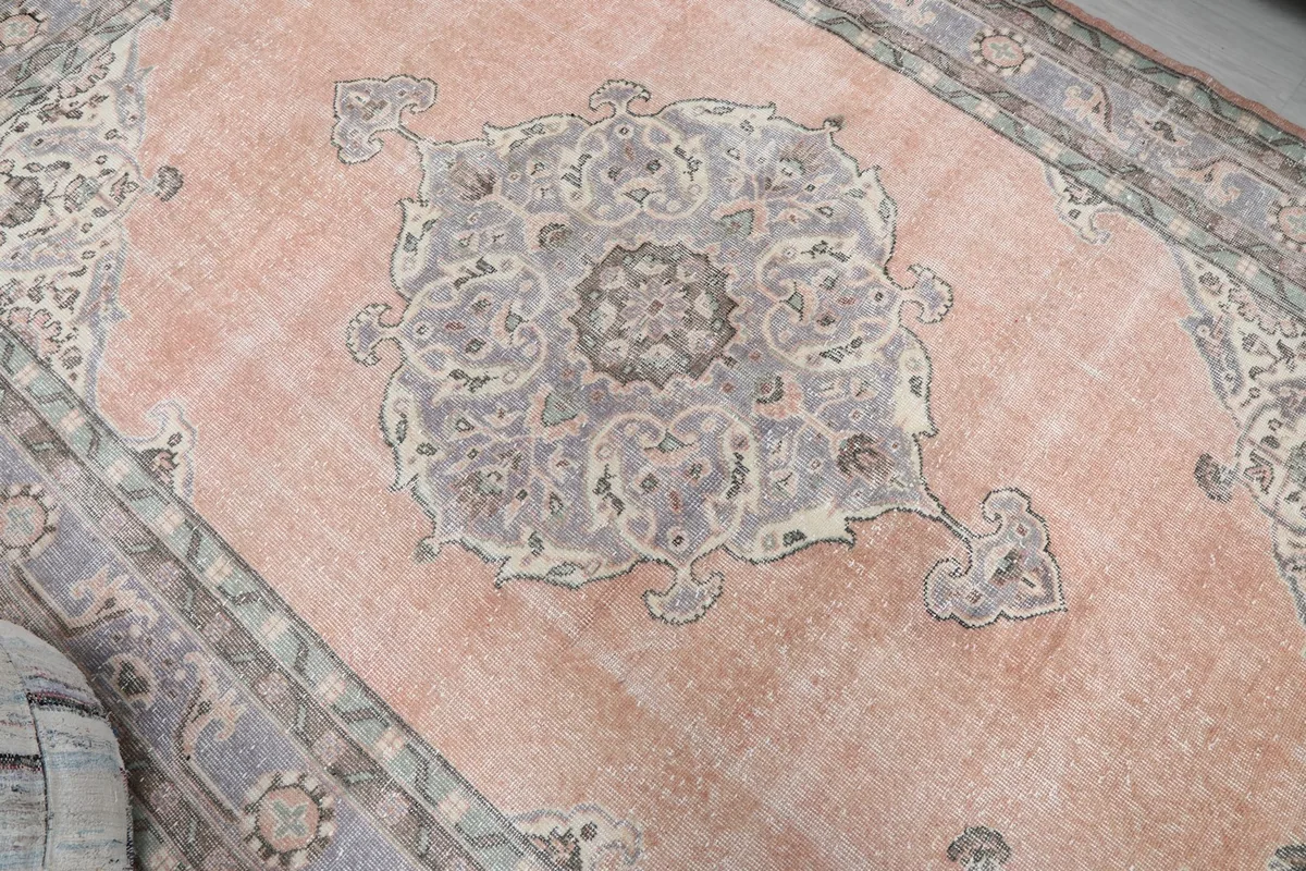 Overhead view focusing on the central gray medallion and the faded orange field.