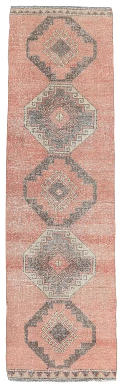 Full top view of the 2'9" x 10'7" rose and charcoal geometric vintage Anatolian runner rug.