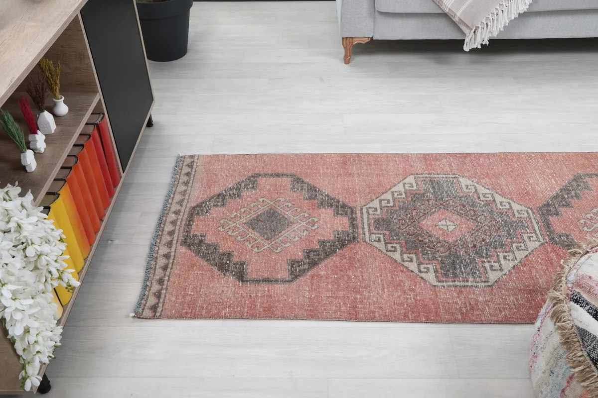 Angle view looking down the length of the runner rug, showing multiple geometric patterns.