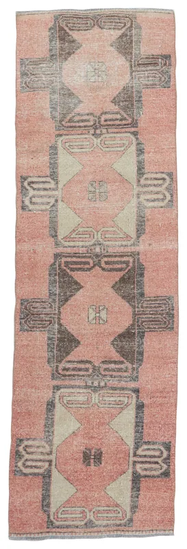 Full overhead view of the 2'8" x 10'7" rose, gray, and beige vintage Anatolian runner rug.