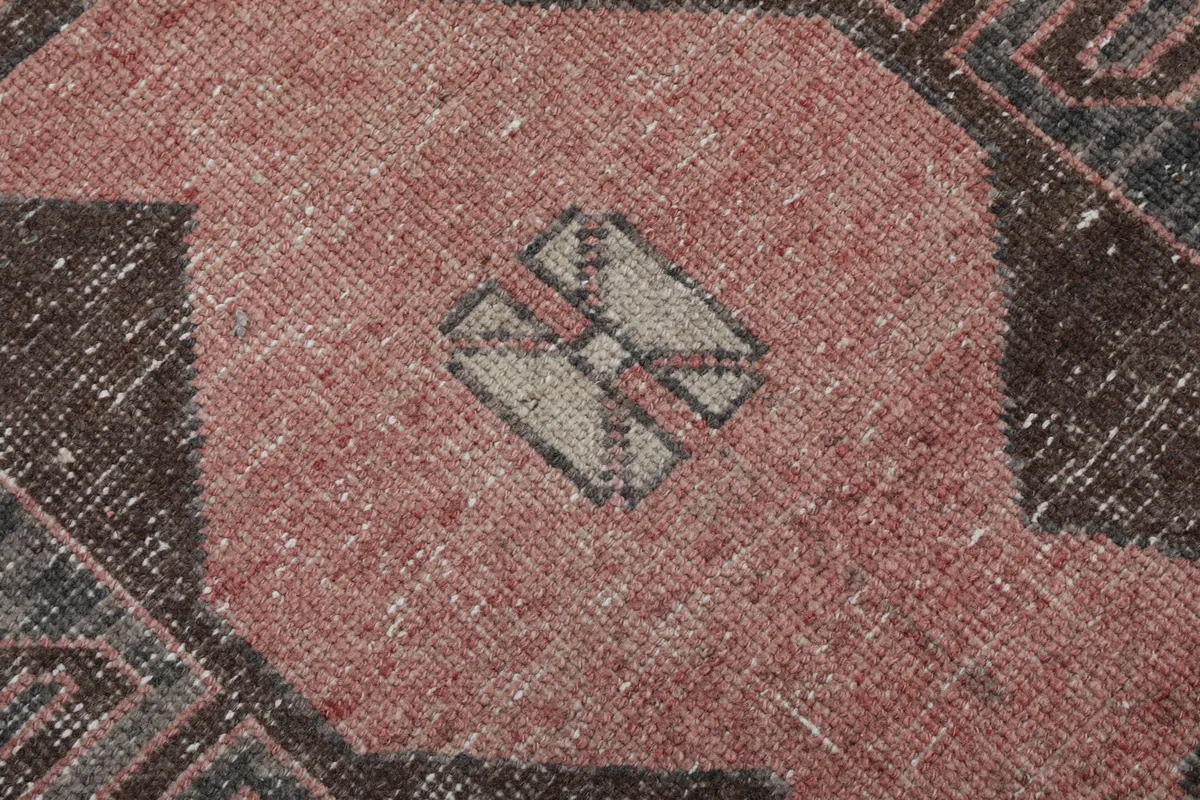 Close-up of a central geometric motif, highlighting the texture and color blend of the wool.
