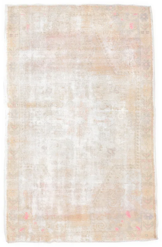 Full overhead view of the beige and rose vintage Anatolian rug on a white background
