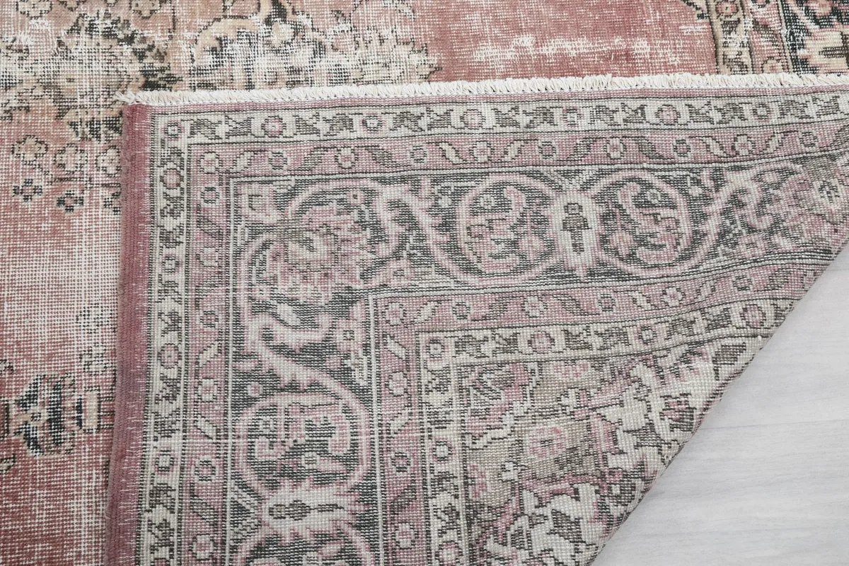 Close-up of the rug's edge, showing the low wool pile and tight hand-knotted construction