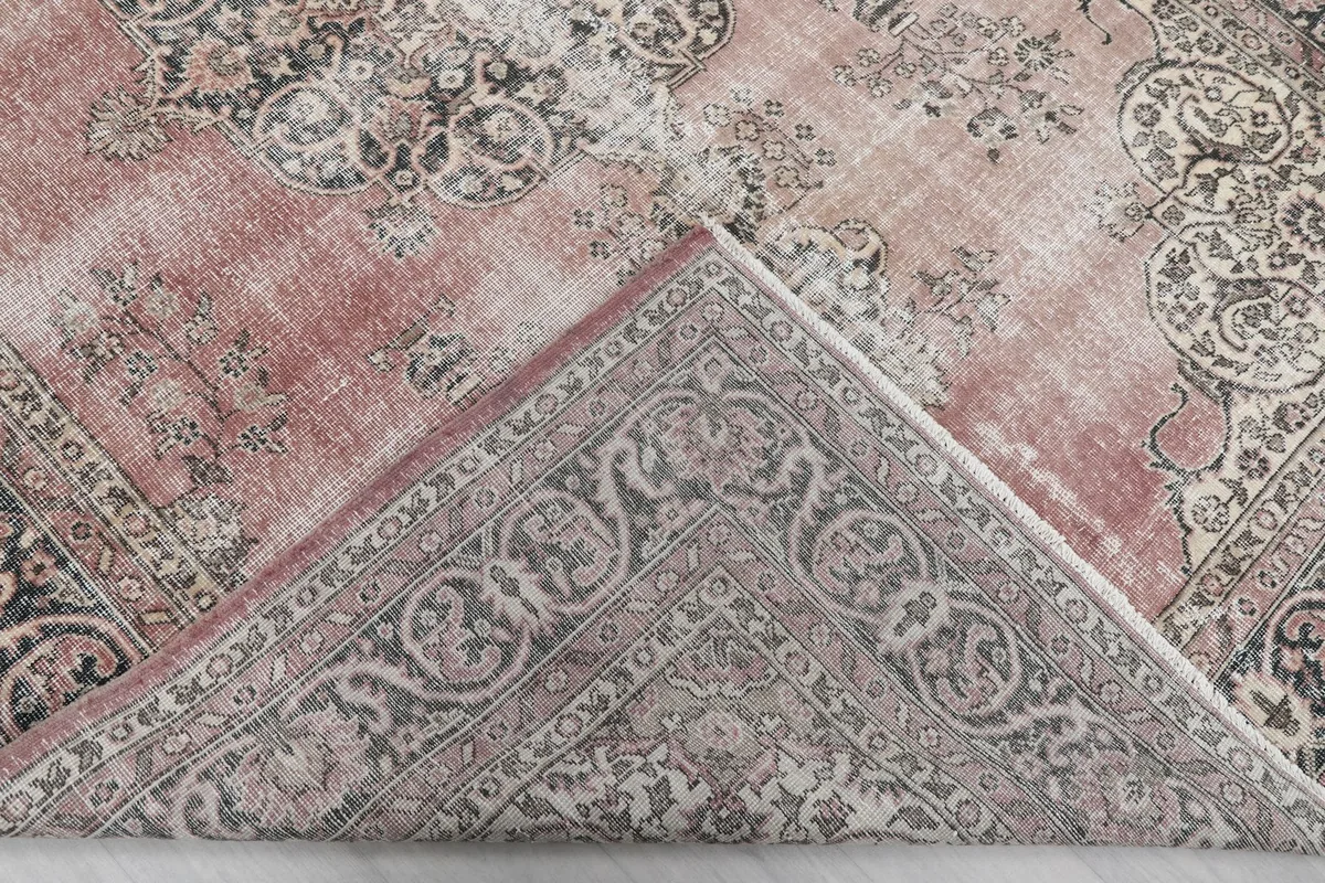 View of the back of the rug, revealing the hand-knotted cotton foundation and wool pile