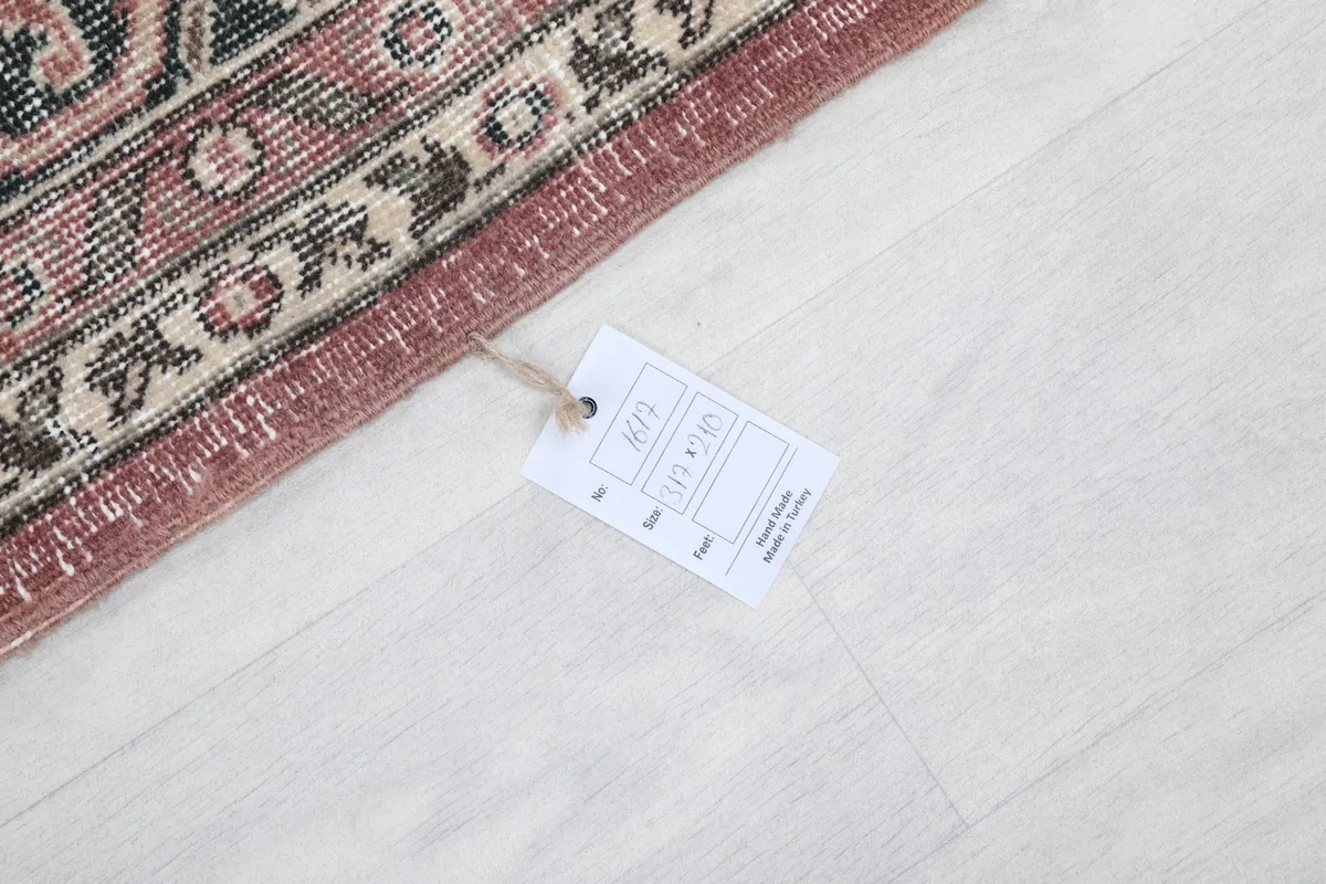 Rug tag displaying details like size and material, attached to the corner of the rug