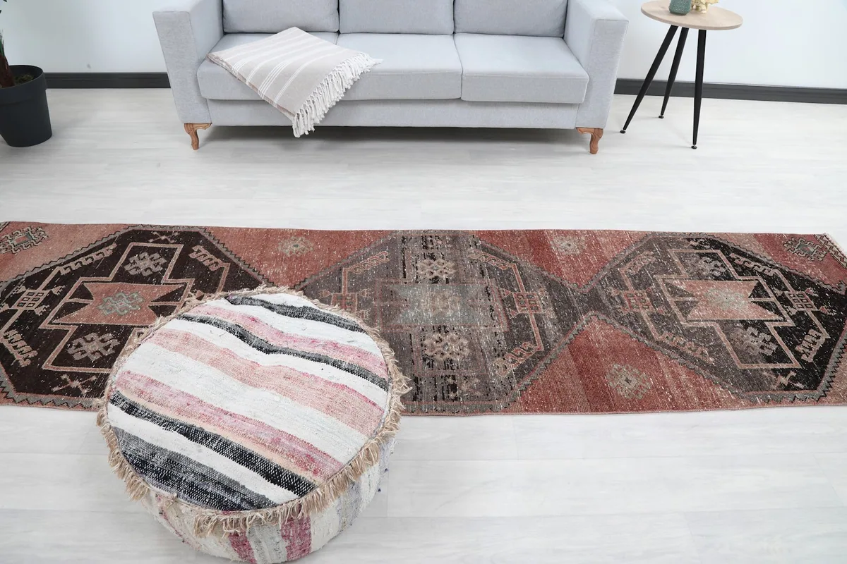 Full room view of the rug, positioned centrally in a hallway-like setting