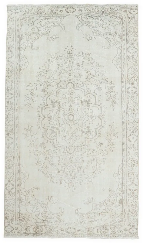 Full overhead view of the ivory and gray vintage Anatolian rug with a central medallion