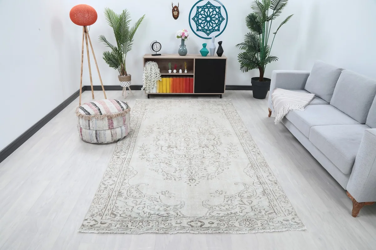 Ivory and gray floral medallion rug in a modern living room setting with a light gray sofa