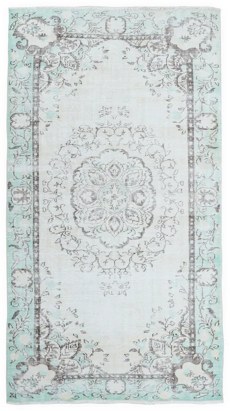 Full overhead view of the ivory, green, and brown vintage Anatolian rug